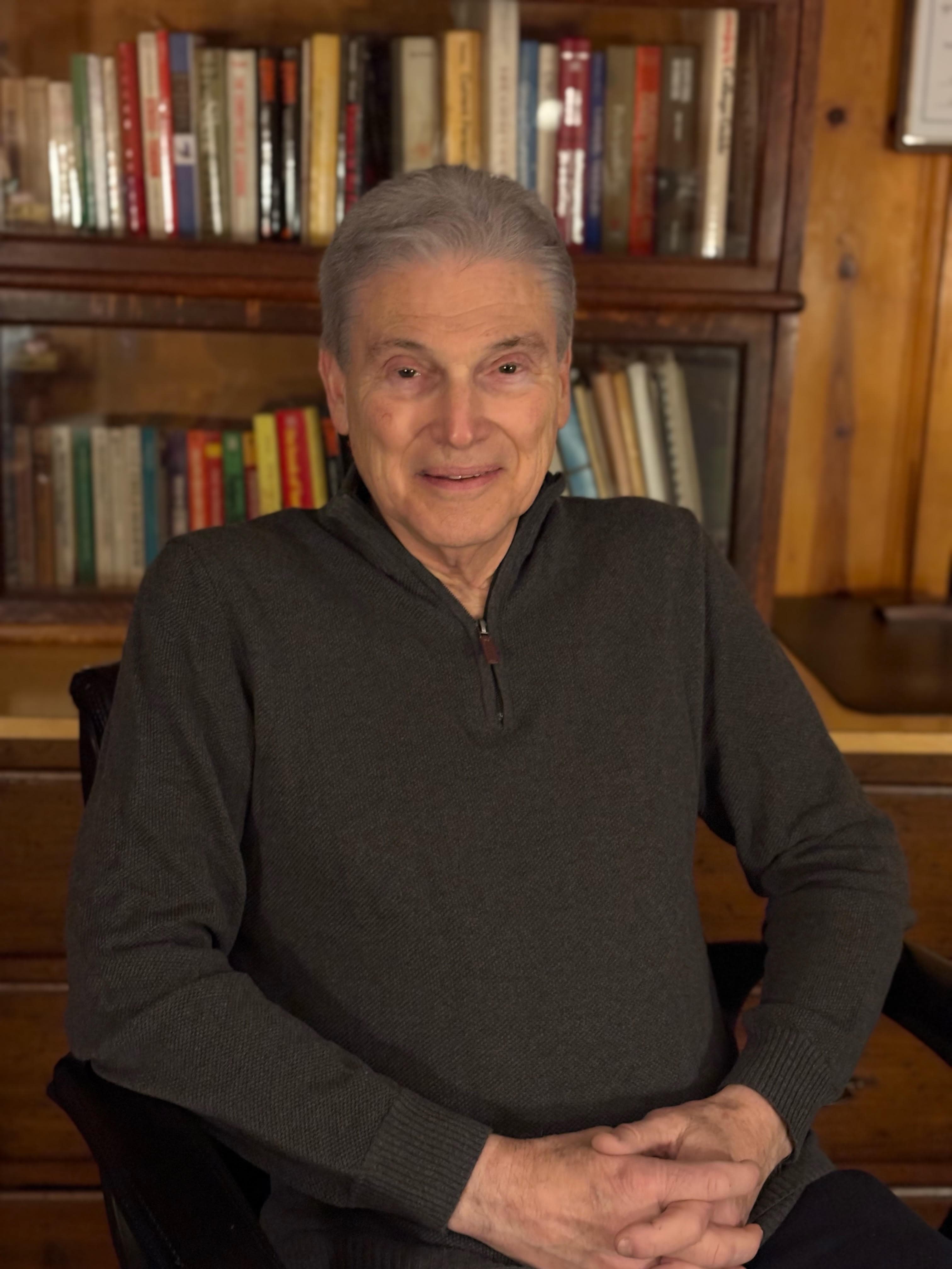 Dr. Robert T. Bleck smiling in his office library